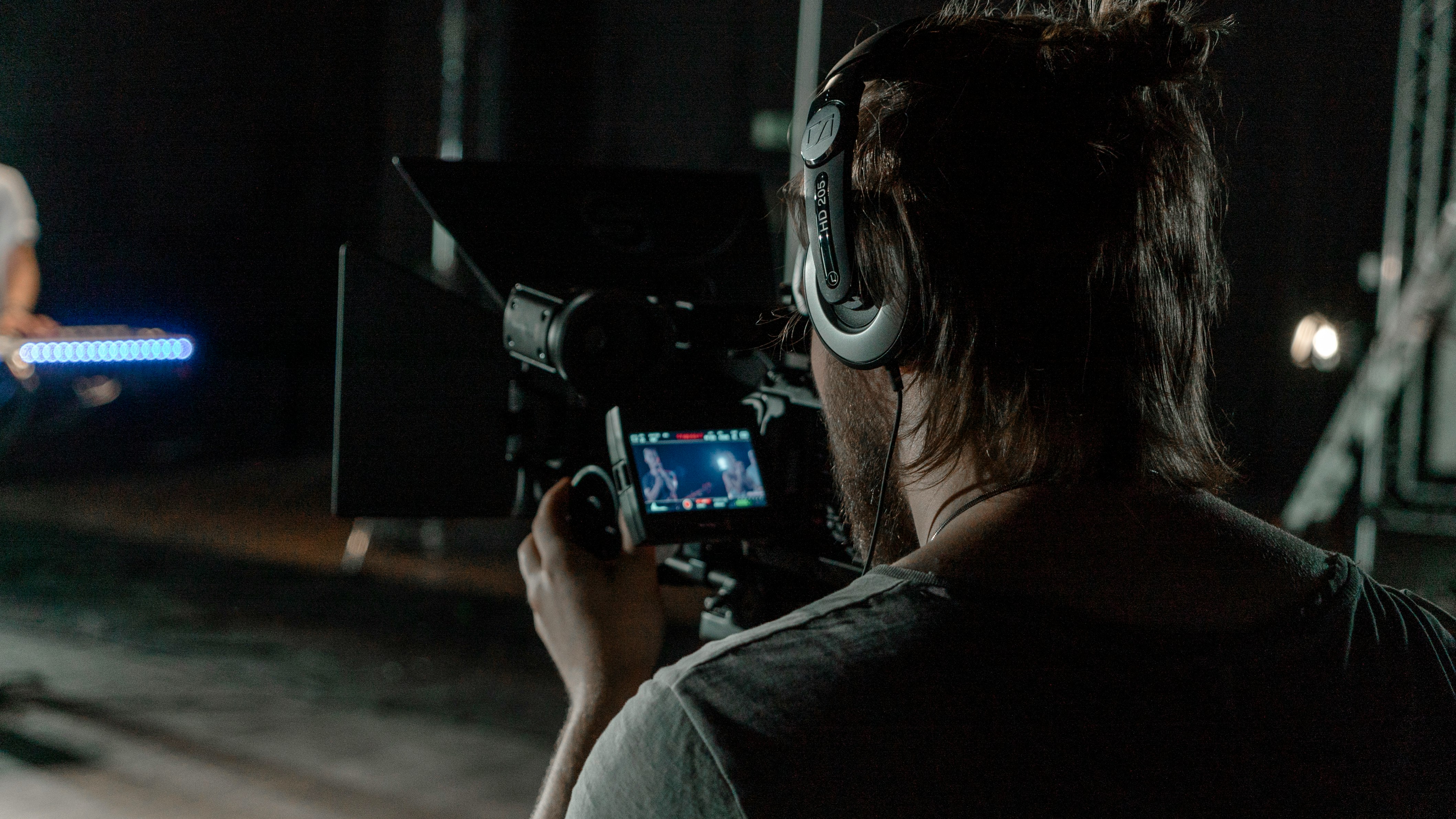 man in gray shirt holding camera